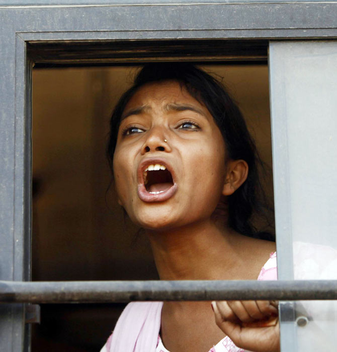 A demonstrator shouts slogans from inside a bus after she was detained by police near the Rashtrapati Bhavan during a protest rally organised by various women's organisations in New Delhi December 21, 2012.