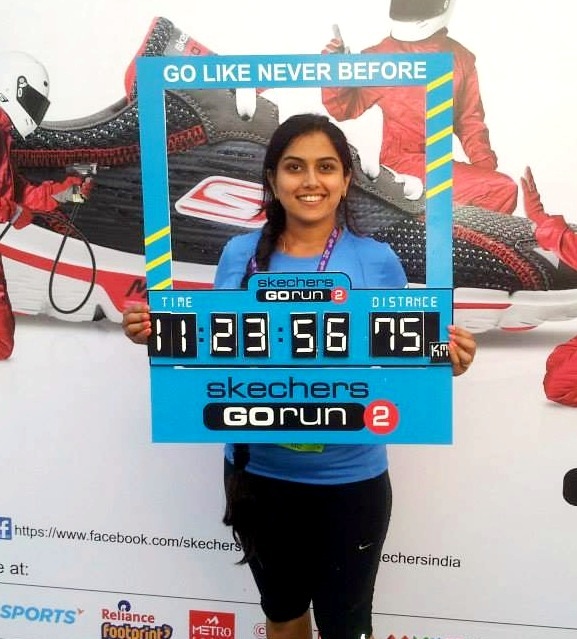 Deepa Katrodia at the end of her Bangalore Ultra Marathon holding up her timing.