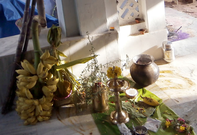 An offering of rice, bananas, betel leaf and sugarcane is kept outside the house