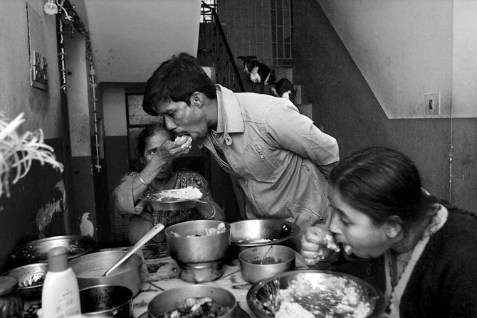 Sandip Karan takes a meal in the midst of treatment. He lives with his mother Saraswati (left) and wife Moumita (right). He has a child, not seen in the photograph.
