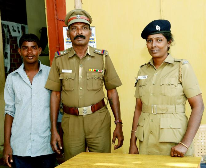 Venkatesh, left, with Sub-Inspector Panneerselvam of the Anna Square police station, centre.