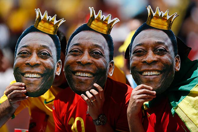 Fans hold up Pele masks before the 2014 World Cup quarter-finals between Argentina and Belgium at the Brasilia national stadium in Brasilia July 5, 2014.