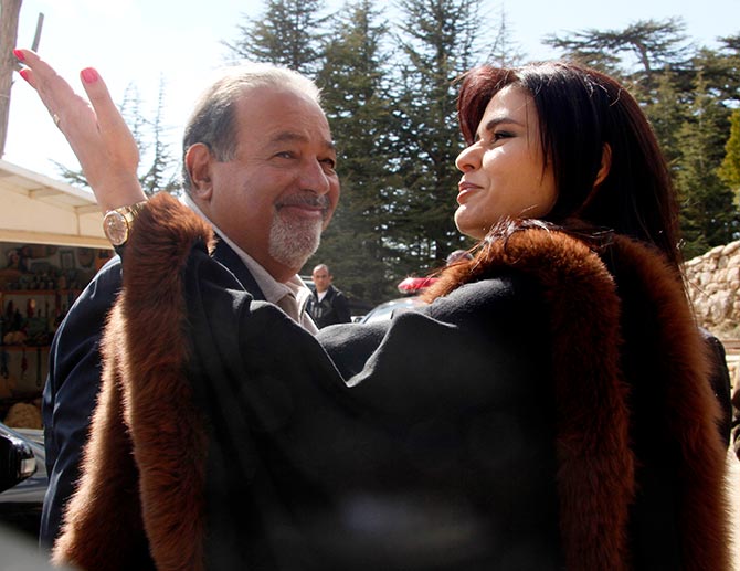 Lebanese MP Strida Geagea welcomes Mexican tycoon Carlos Slim, who is of Lebanese descent, as they tour Bcharreh's cedars forest, northern Lebanon March 17, 2010.