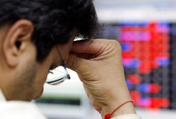 A stock broker reacts while trading at a brokerage firm in Mumbai March 13, 2008 when Indian shares fell nearly 5 per cent by Thursday afternoon to their lowest in more than six months