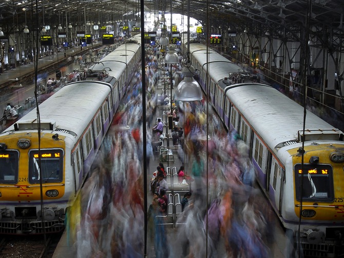 Commuters disembark from crowded suburban trains during the morning rush hour at Churchgate railway station in Mumbai.