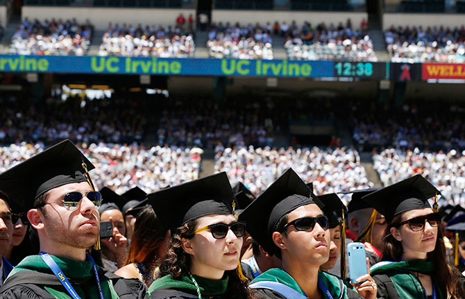 Students listen as US President Barack Obama speaks during the commencement ceremony for the University of California, Irvine at Angels Stadium in Anaheim, California.