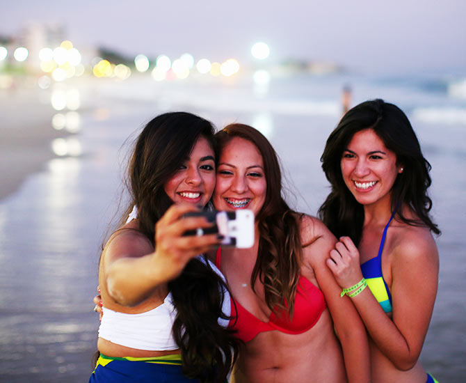 Girls take a selfie on Ipanema beach in Rio de Janeiro, Brazil.