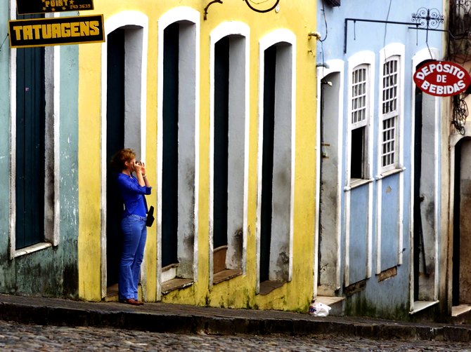A tourist takes a snapshot in the Pelourinho district of Salvador, in the northern coastal state of state of Bahia,