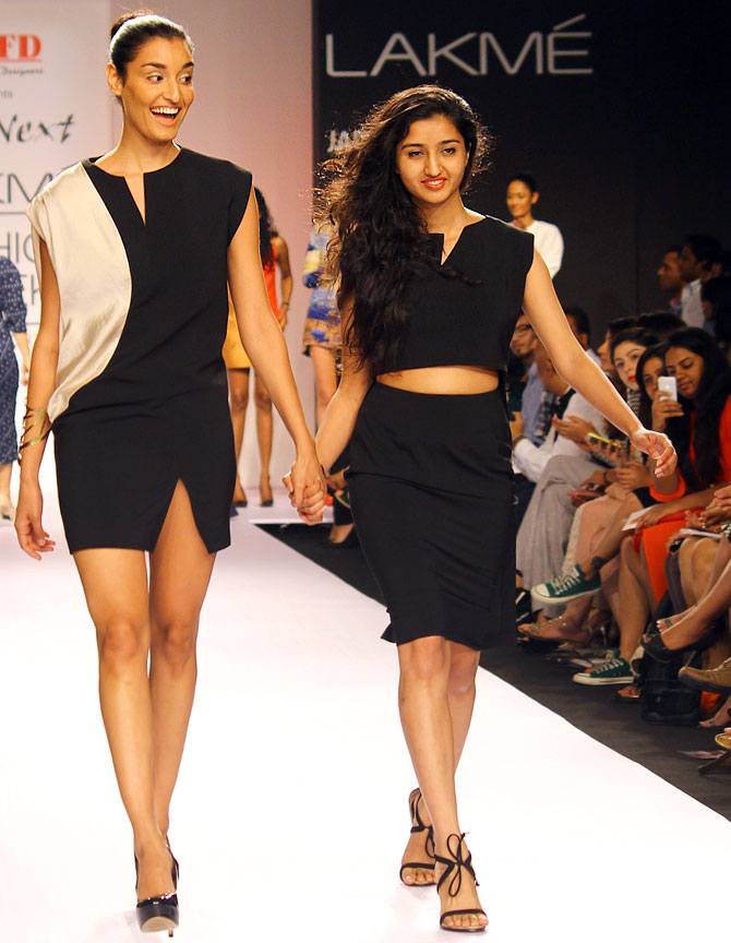 Chandni Mohan walks with a model at the end of her collection