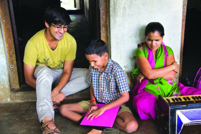 Param Shah with a visually-challenged child in India