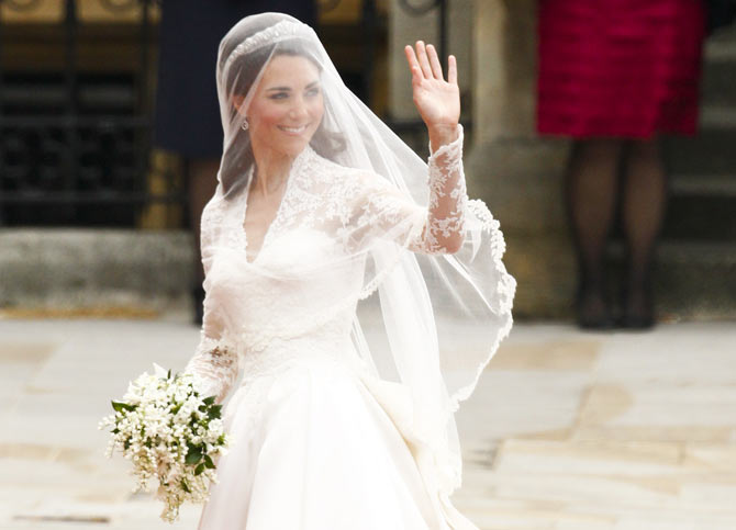 Kate waves as she arrives at Westminster Abbey for her marriage to Prince William.