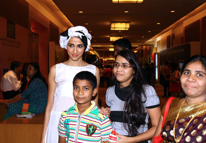With little or no hang-ups, Alesia is one of the most easygoing people at Lakme Fashion Week. Here she poses readily with a few guests for a photograph.