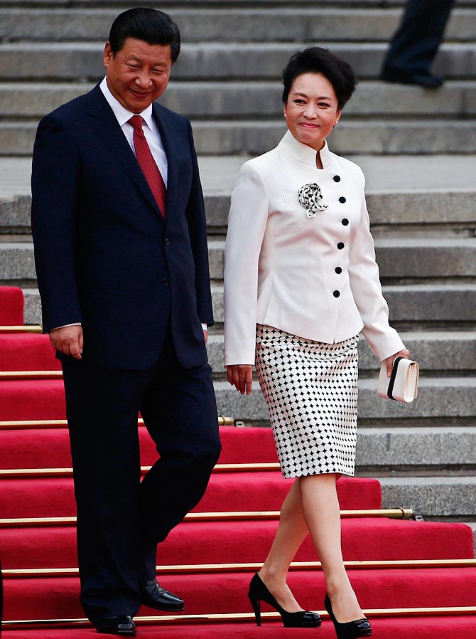 Chinese President Xi Jinping (L) and his wife Peng Liyuan seen outside the Great Hall of the People in Beijing.