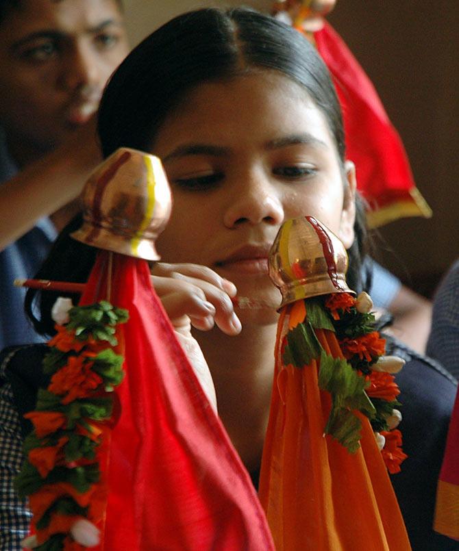 A young girl paints a gudi ahead of Gudi Padwa in Mumbai, Maharashtra