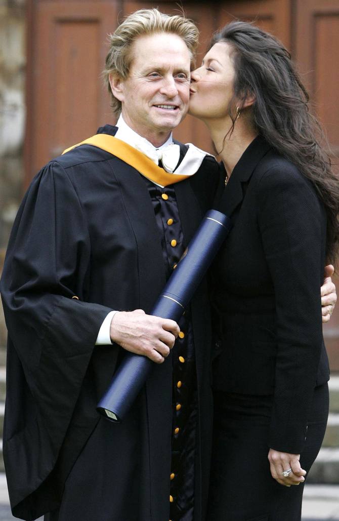 Catherine Zeta-Jones kisses her husband, US actor Michael Douglas, after he received an honorary Doctorate of Laws at St. Andrews University in Scotland June 21, 2006.