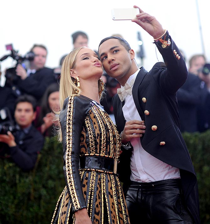 Rosie Huntington-Whiteley (L) and Olivier Rousteing