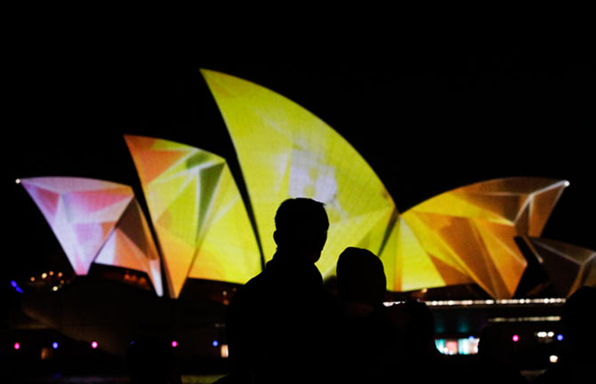 A couple looks at the Sydney Opera House