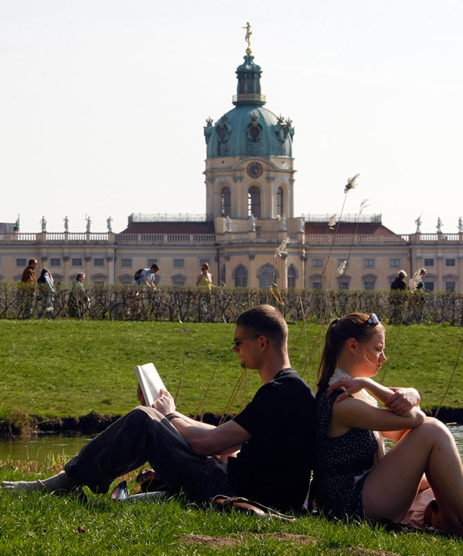 People enjoy a sunny spring day at the park of Charlottenburg castle in Berlin.