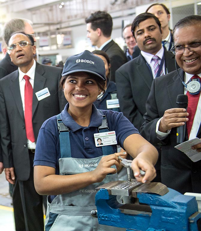  In this photo provided by the German Government Press Office (BPA), German President Joachim Gauck is instructed by trainee Meghana during his visit at Bosch factory in on February 7, 2014 in Bangalore, India. Gauck is in India for an official six day visit.