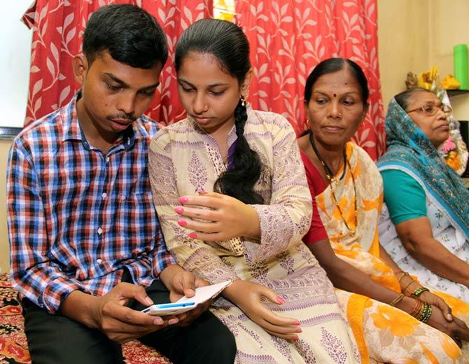 Monika More, right, checks her HSC result on the phone