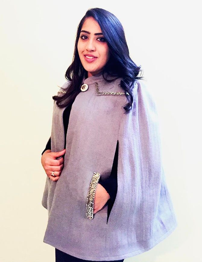 The fashion designer wearing neo prene skirt set with khadi wool hand beaded cape from her own label