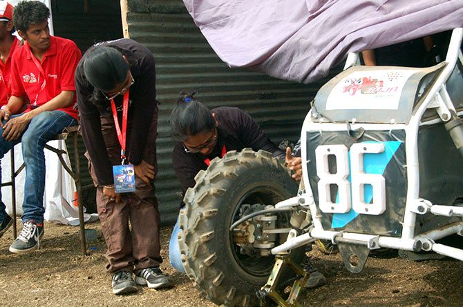 Saachi's team-mates fix a tyre that had come off during the endurance test. Though they are not sure if they will complete the task before the end of the four-hour competition, they believe in a never say give up spirit.