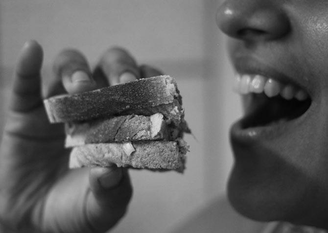 Hungry person eating bread