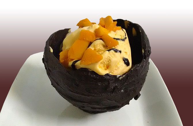 Mango icecream in chocolate bowl