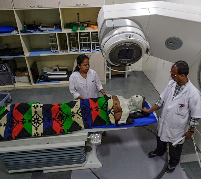 IMAGE: Radiologists examine a cancer patient before operating a computerised linear accelerator machine for radiation treatment at the North Bengal Oncology Centre, a cancer hospital, on the outskirts Siliguri