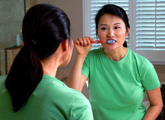 woman brushing teeth