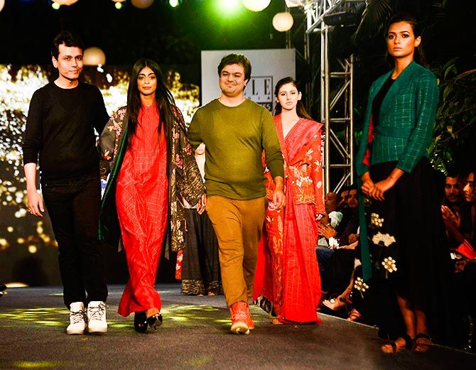 Rachel Varghese flanked by the designers