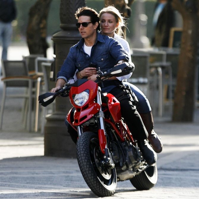 Tom Cruise and actress Cameron Diaz ride a motorbike on the set during the filming of 