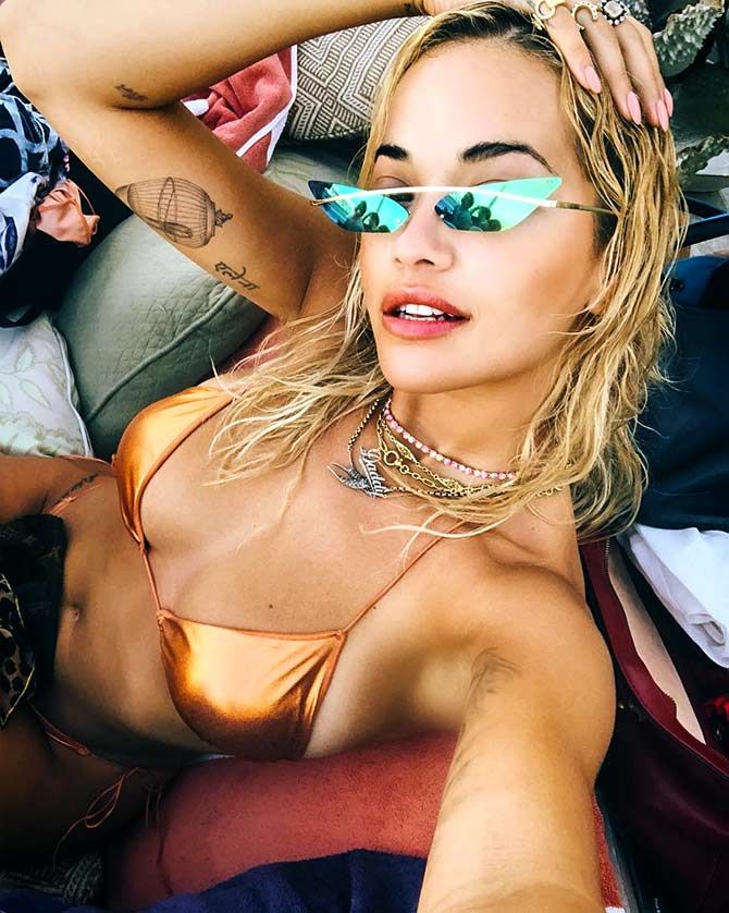 Rita Ora flaunts holographic bikini
