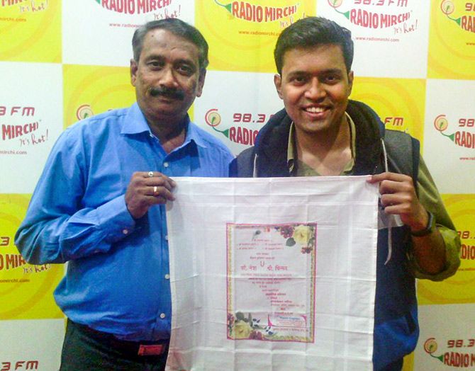 Uday Gadgil poses with the rumaal patrika he designed for his daughter Netra's wedding in 2016