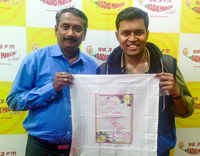 Uday Gadgil poses with the rumaal patrika he designed for his daughter Netra's wedding in 2016