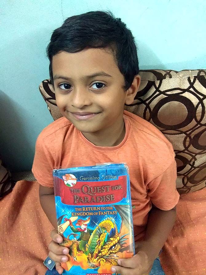 Abhinav JR poses with the book The Quest for Paradise