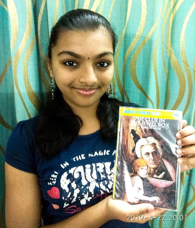 Amogha Raghuvir poses with her favourite book