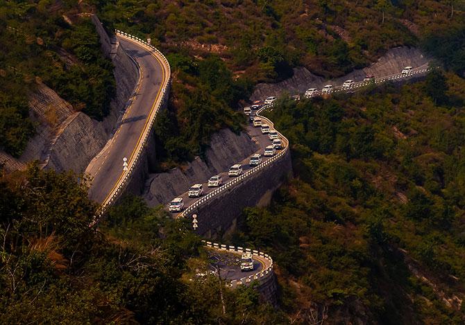 The convoy pasing multiple layered winding roads