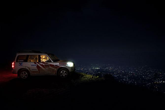 The convoy of Scorpios and XUV500s crossing scenic mountains in Bhutan