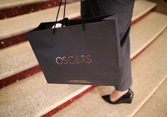 An employee carries the Oscar Everyone Wins goodie bag