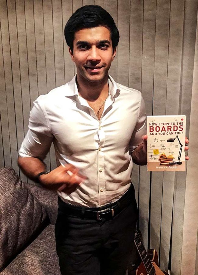 Gaurav Sood poses with his book How I Topped the Boards and You Can Too 