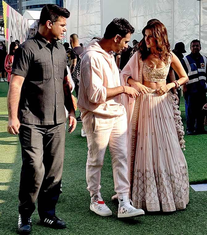 Tara Sutaria, Punit Balana and entourage walk from the runway to the celebrity green rooms Photograph: Kshamaya Daniel/Rediff.com.