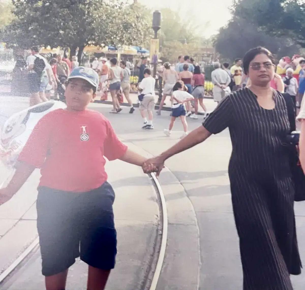 With a younger Anant in Disneyland, Paris