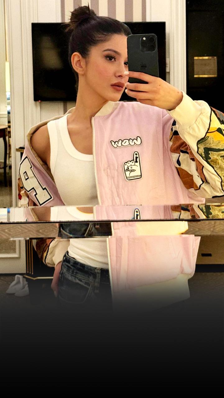 Shanaya Kapoor is wearing a white top; her hair is in a top knot.