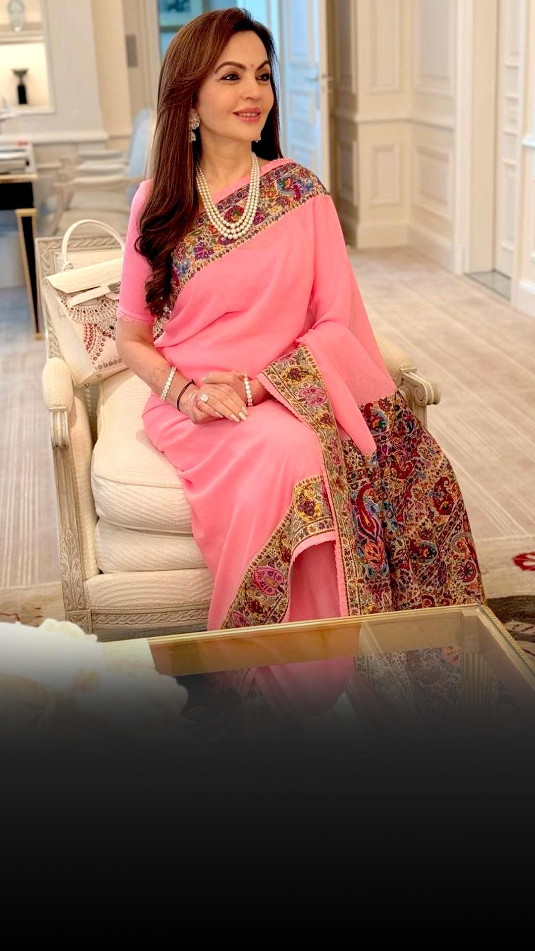 Nita Ambani in a pink sari with intricate sozni and kalamkari hand embroidery.