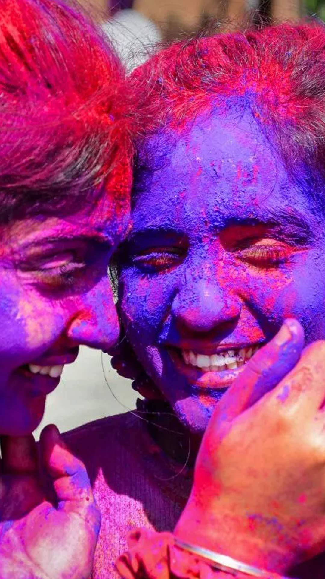 Students smear colour on each other's faces at Guru Nanak Dev University, in Amritsar. 