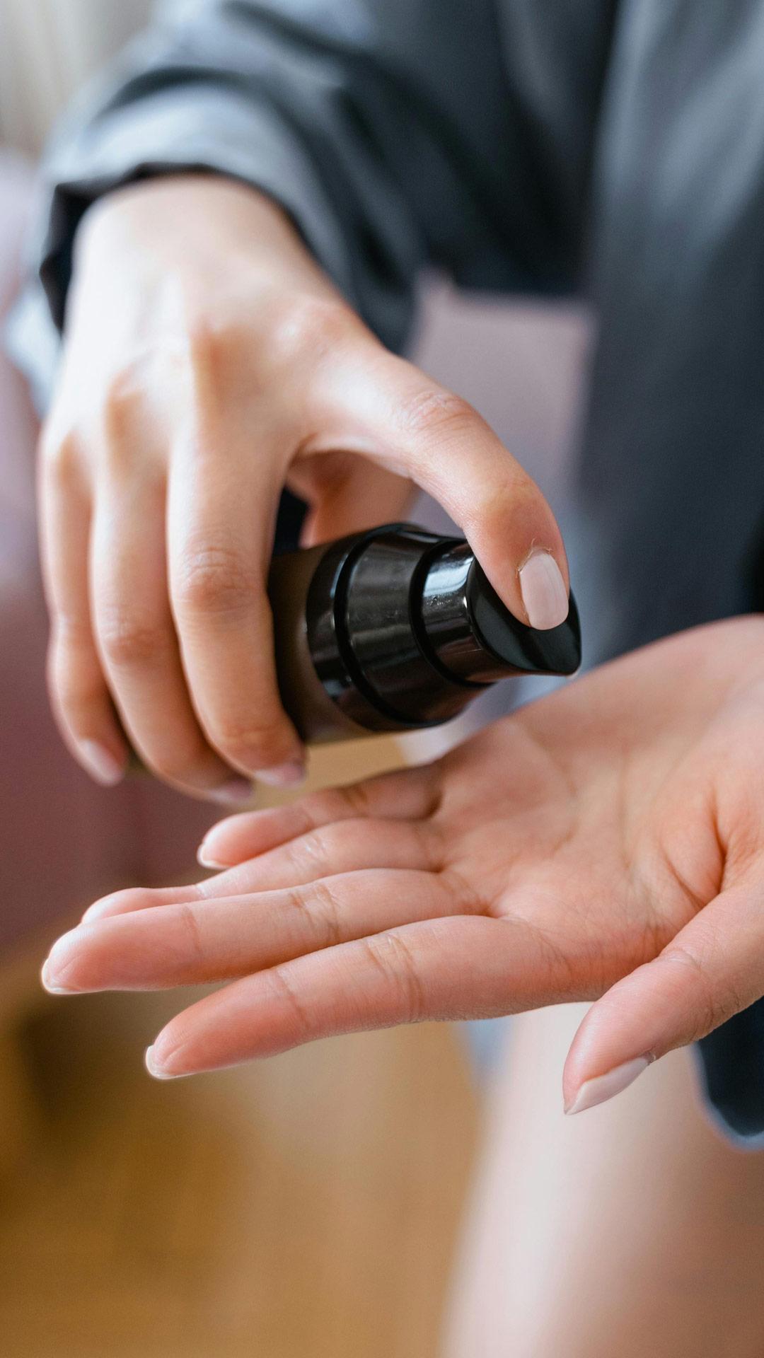 Person Holding Brown Bottle with Oil