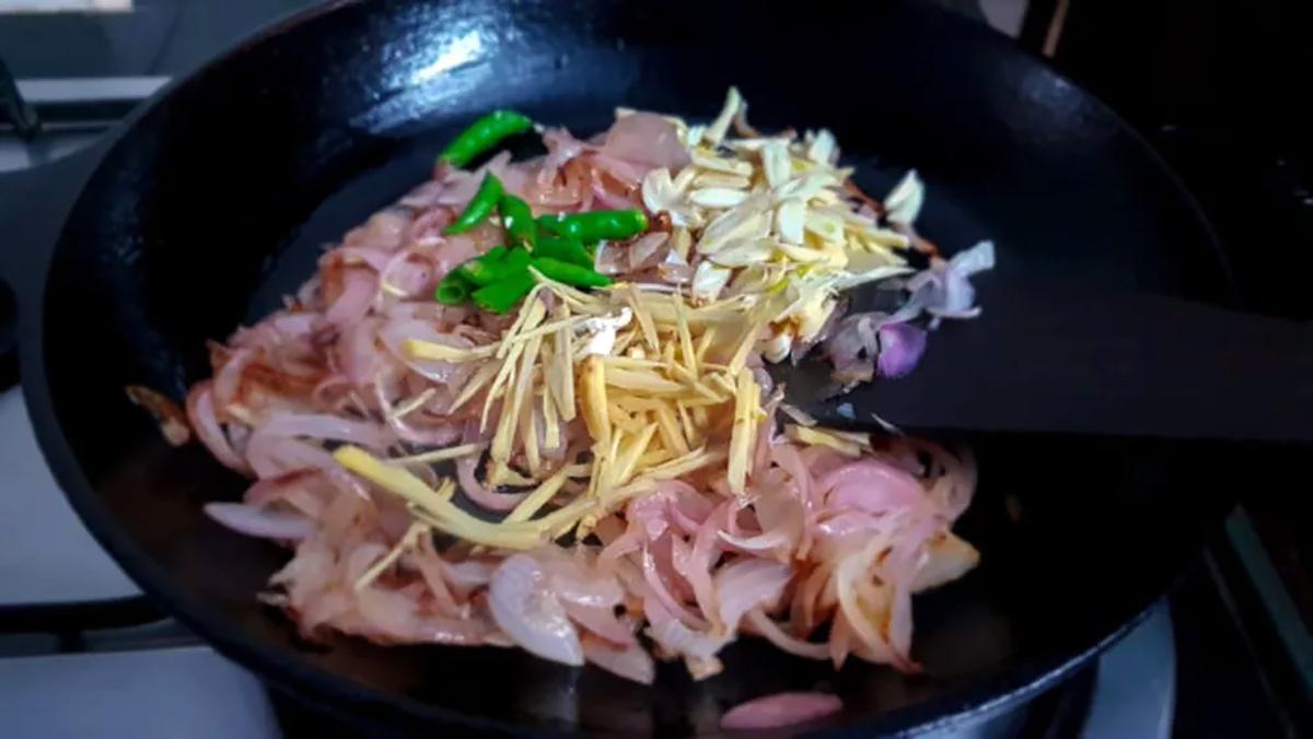 Frying the onions with ginger and chillies