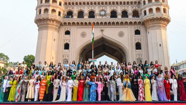 109 Miss World 2025 contestants pose for a picture during their visit to the Charminar