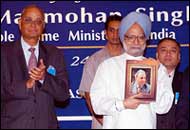 Prime Minister Manmohan Singh releasing a special cover on JRD Tata at the JRD Tata Centenary Celebration in New Delhi on Tuesday. Hari Shankar Singhania, Chairman, JRD Tata Centenary Celebration Committee (left) and Mahendra K Sanghi, President, Assocham (right), look on. Photo: SAAB Press